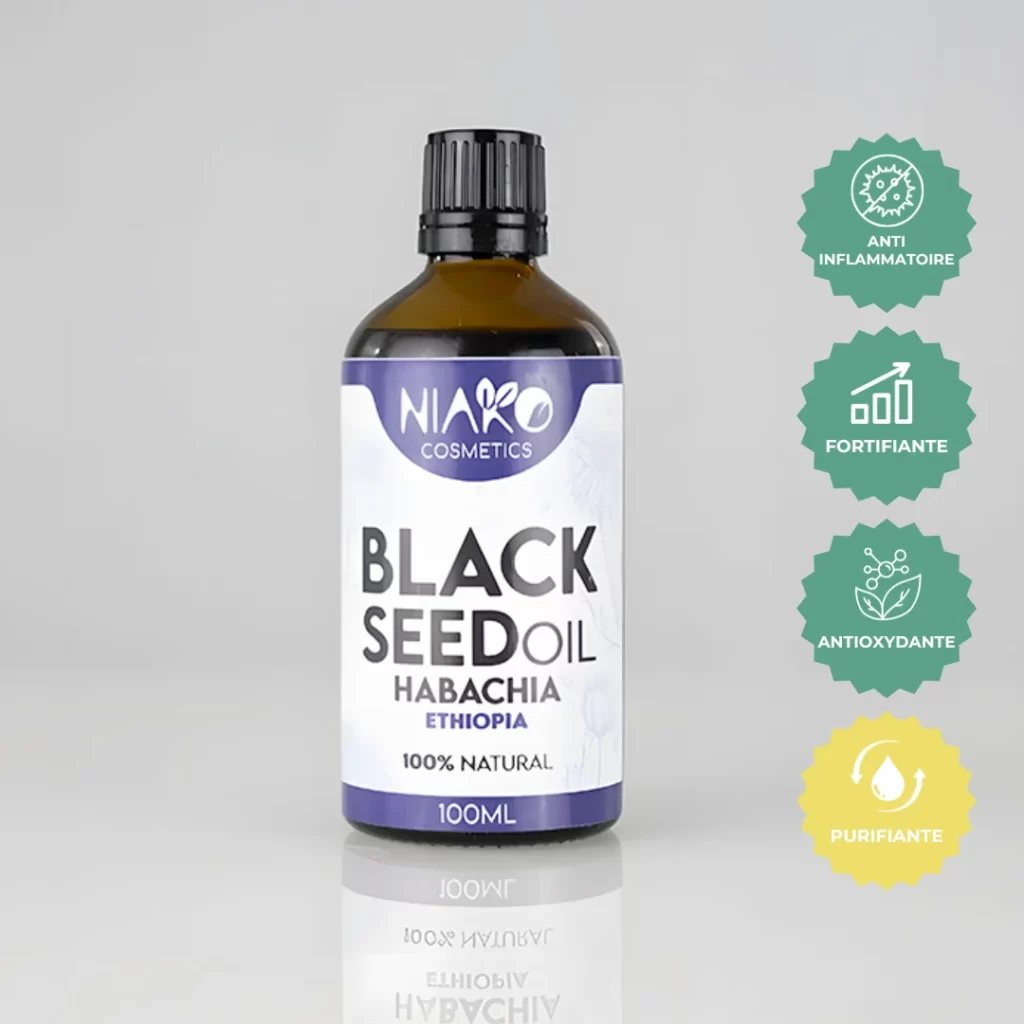 Flacon d'huile de nigelle Niako Cosmetics, étiquette violette, avec logos de bienfaits : anti-inflammatoire, fortifiant, antioxydant, purifiant.